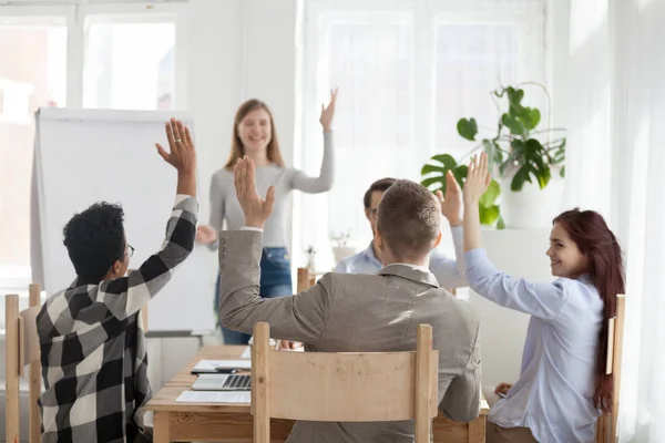 Diverse employees raise hands participating in teambuilding — Stock Photo, Image