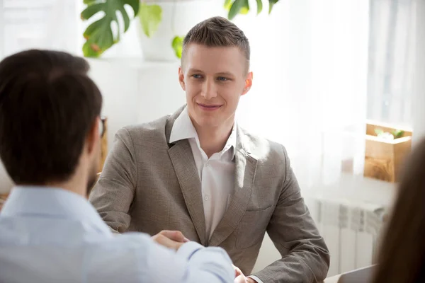 Male colleagues get acquainted handshaking at meeting — Stock Photo, Image