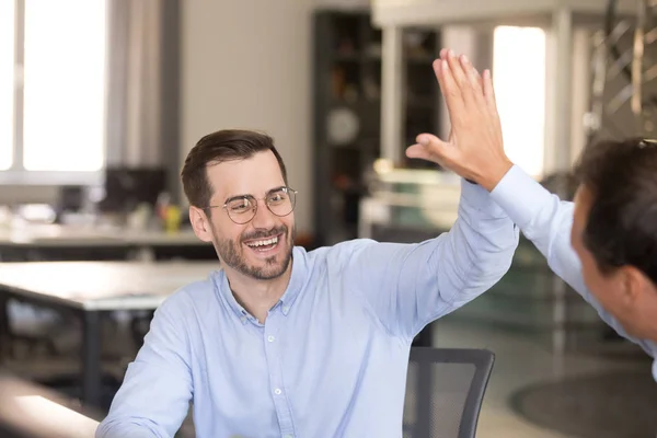 Happy male employee giving high five to colleague — Stock Photo, Image