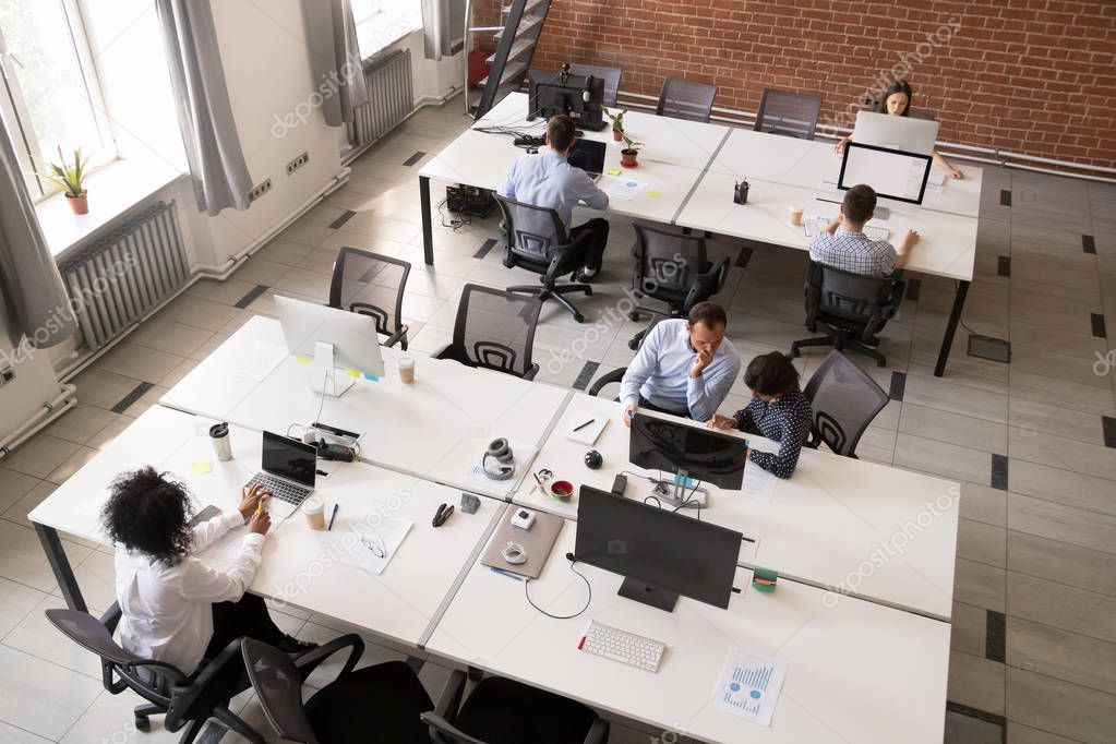 Employees working together in modern open office space