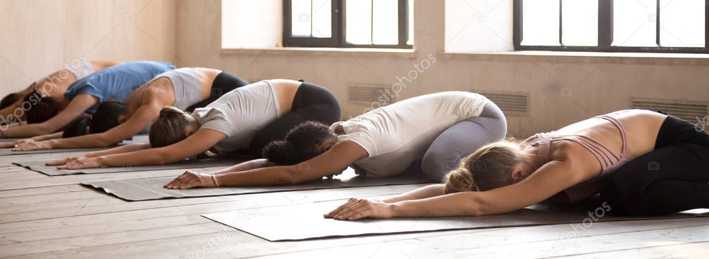 Women doing Child Pose during yoga session 