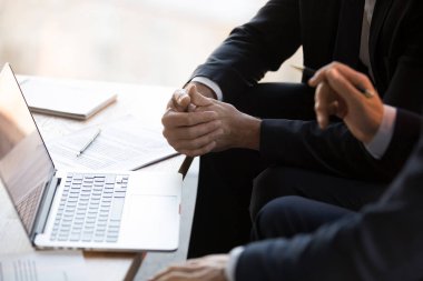 Close up businessmen in formal suits using computer working toge clipart