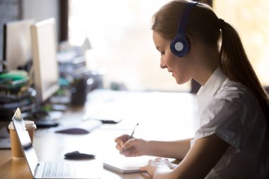 Kulaklık yazma notlar çalışma online ile t giyen odaklı kadın