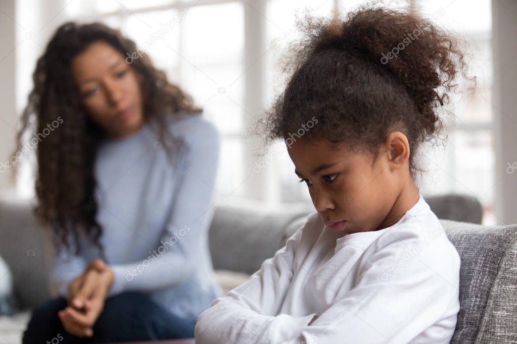 Mom or psychologist tries to talk to upset african girl