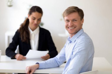 Head shot portrait of male applicant at successful job interview