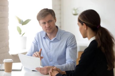 Doubting hr manager looking with suspicion at applicant 