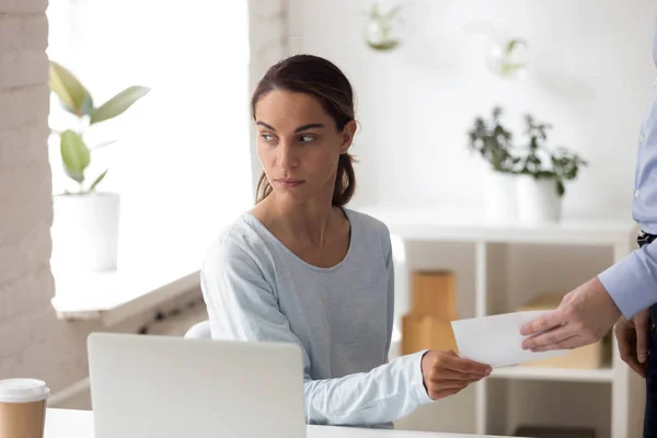 Worried woman taking envelope with bribe from person at workplac — Stock Photo, Image