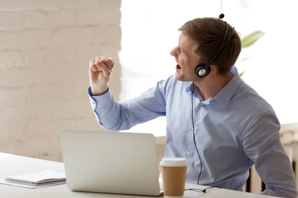 Funny men in headphones enjoying music and singing at workplace — Stock Photo, Image