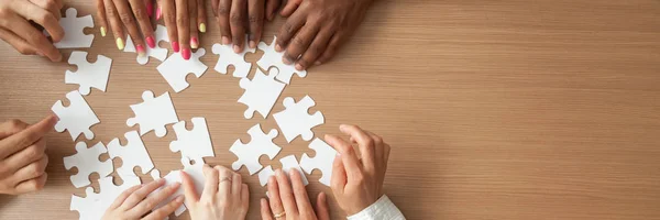 Above panoramic view hands of diverse people assembling jigsaw puzzle — Stock Photo, Image