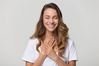 Happy pleased young woman thanking for care feel grateful  clipart