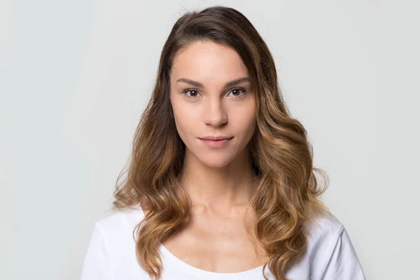 Millennial woman looking at camera on white background, portrait image — Stock Photo, Image