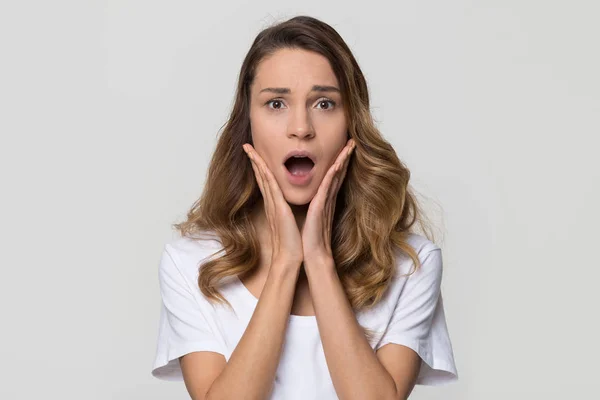 Shocked woman feeling terrified looking at camera on white background — Stock Photo, Image