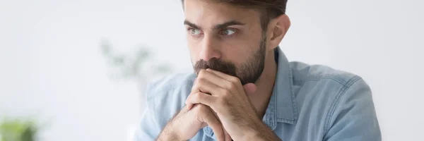 Serious focused businessman holds hands on chin thinking making decision — Stock Photo, Image