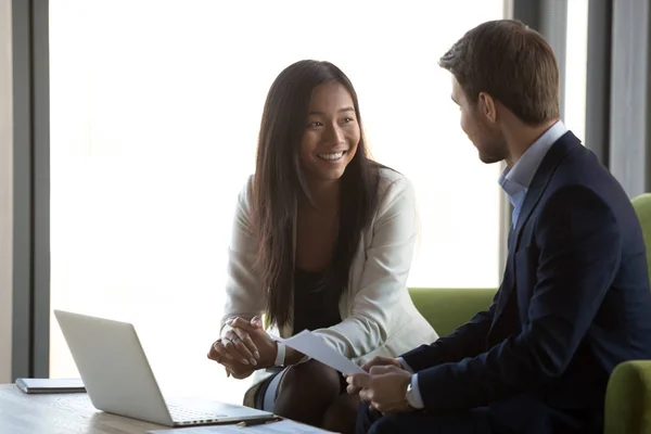 Diverse financial advisor and client having conversation at business meeting