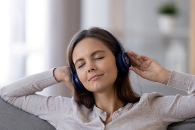 Dinlerken kulaklık giyen rahat sakin teen kız müzik yatıştırıcı