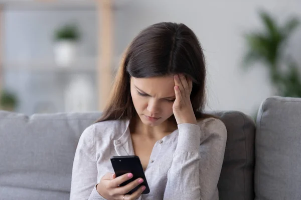 Lonely sad millennial woman feeling hurt heartbroken holding phone — Stock Photo, Image
