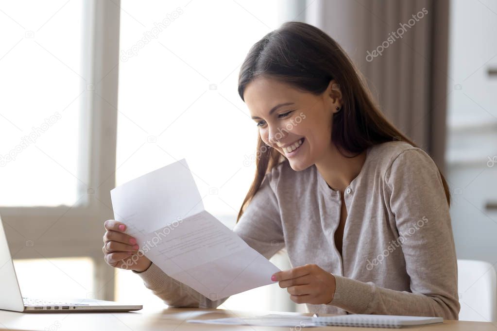 Happy excited woman reading letter with good news, great offer