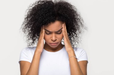 Upset stressed black woman massaging temples feeling pain terrible migraine clipart