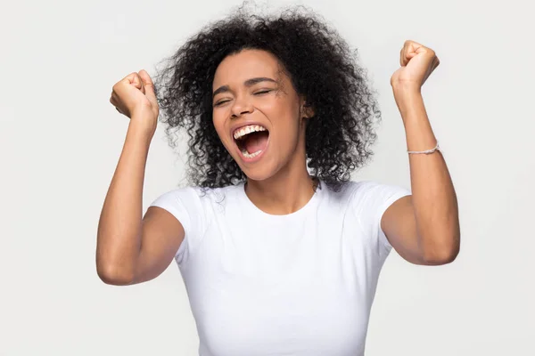Overjoyed young african american woman screaming with joy celebrating victory — Stock Photo, Image