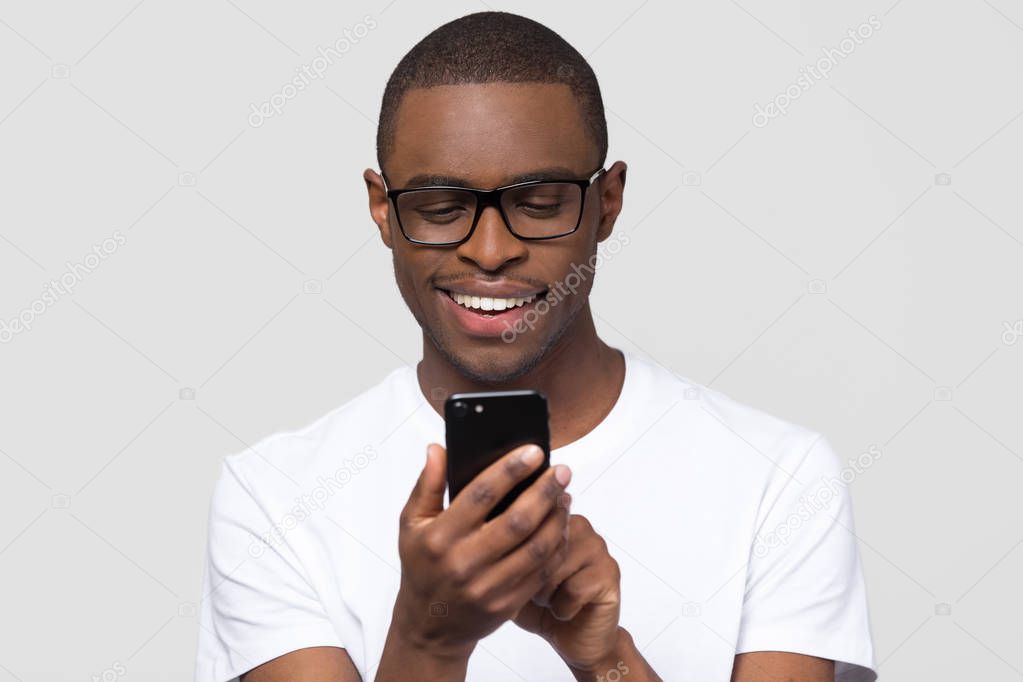 Happy young african man using smartphone gadget social media apps