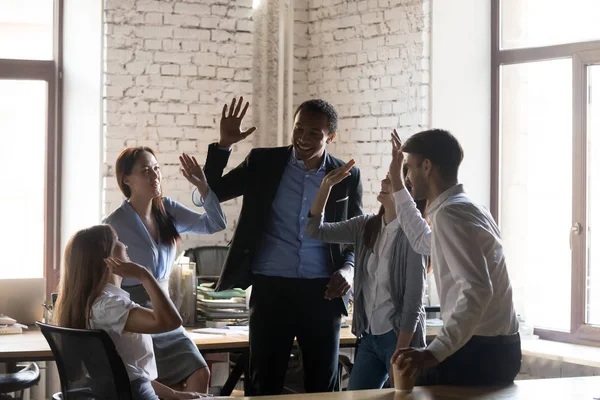 Excited employee give high five celebrating shared success