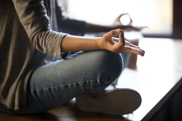 Close up of female meditating on table with mudra hands — Stock Photo, Image