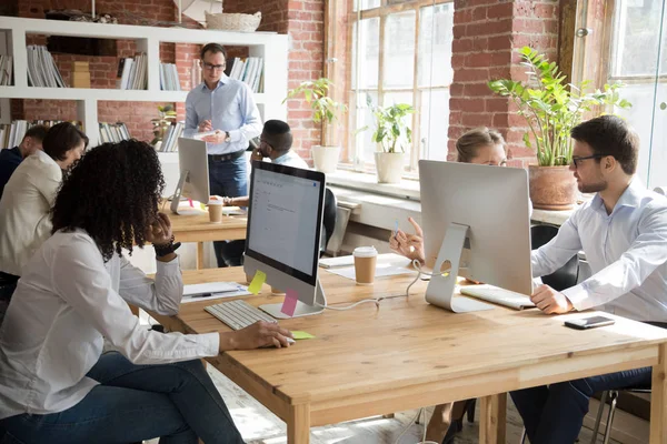 Multi-ethnic employees working on computers in modern office room — Stock Photo, Image