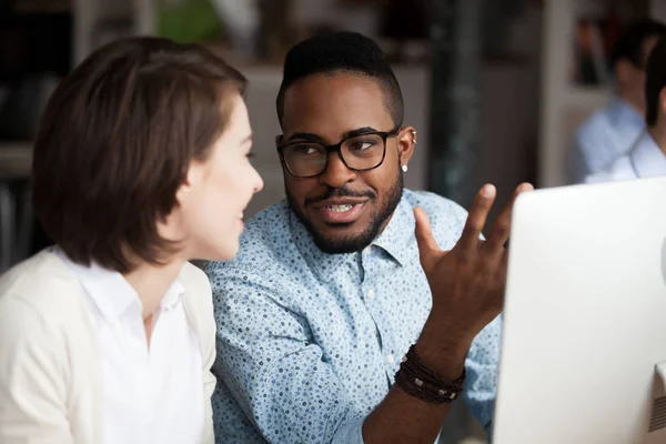 Creative african american and caucasian workers discussing work chatting — Stock Photo, Image