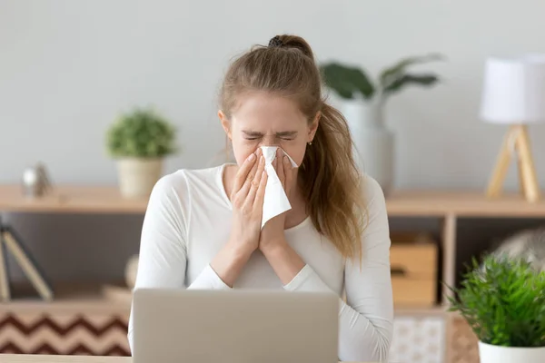 Ill young woman caught cold sneezing wiping running nose — Stock Photo, Image