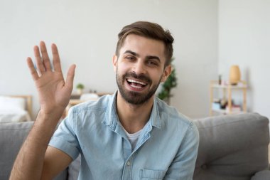 Kameraya bakarak Selam el sallayarak dostça mutlu adam