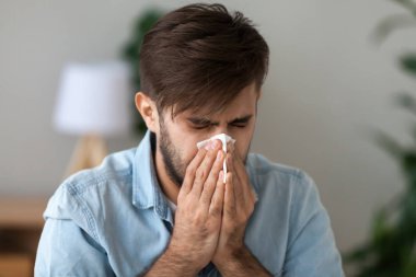 Sick man got flu allergy sneezing in handkerchief blowing nose clipart