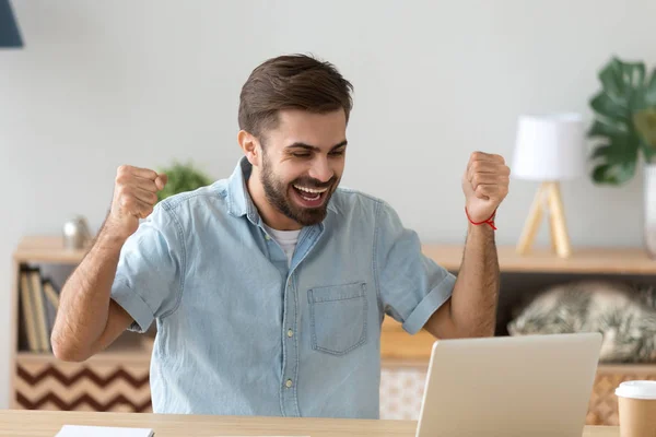 Euphoric young man celebrating success excited by online bet win — Stock Photo, Image