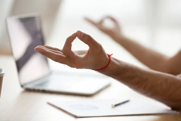 Healthy man meditating at home office desk doing yoga, closeup — Stock Photo, Image