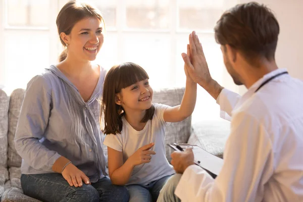 Happy cute child girl giving high five to male pediatrician — Stock Photo, Image