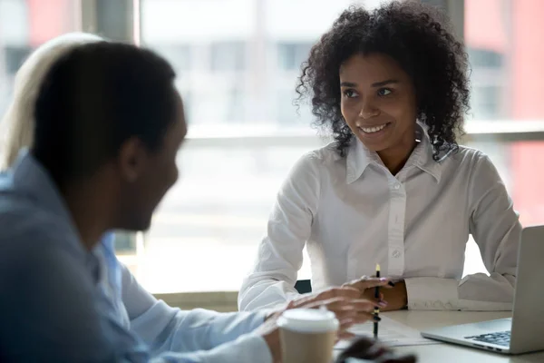 Black team leader having conversation with colleagues during meeting — Stock Photo, Image