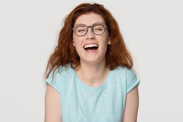 Cheerful happy red-haired young woman in glasses laughing out loud — Stock Photo, Image