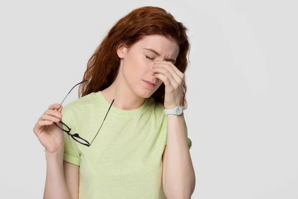 Stressed upset redhead woman feel eyestrain headache take off glasses — Stock Photo, Image
