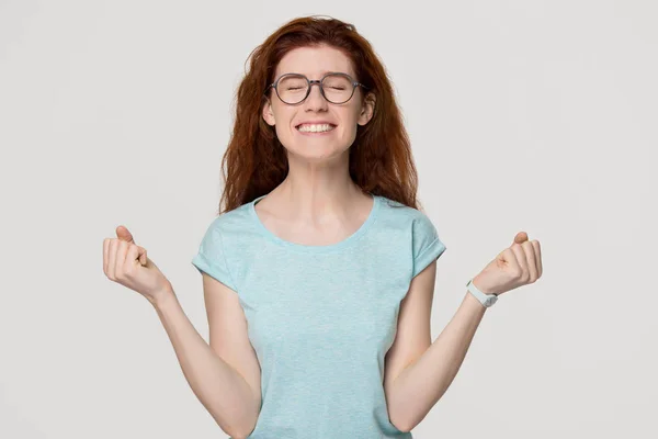 Happy overjoyed red-haired woman in glasses celebrating win success — Stock Photo, Image