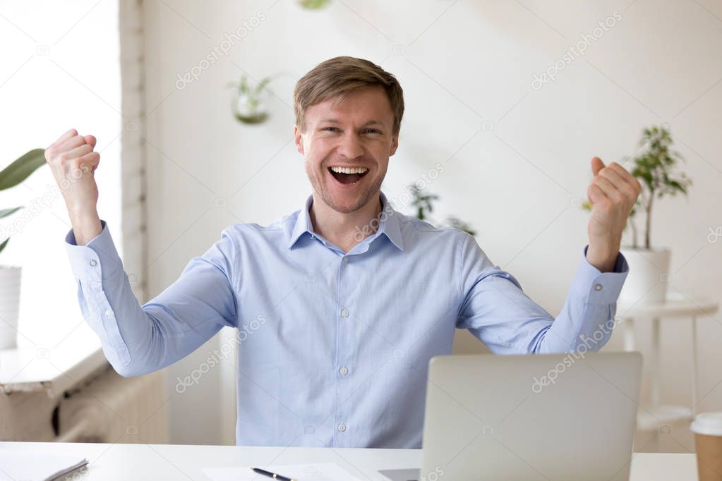 Happy employee looking at camera excited by great news