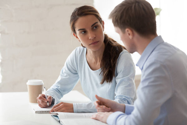 Mixed race and caucasian colleagues studying working together
