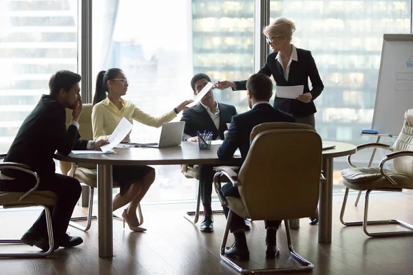 Company executive giving papers presenting new business plan to team — Stock Photo, Image