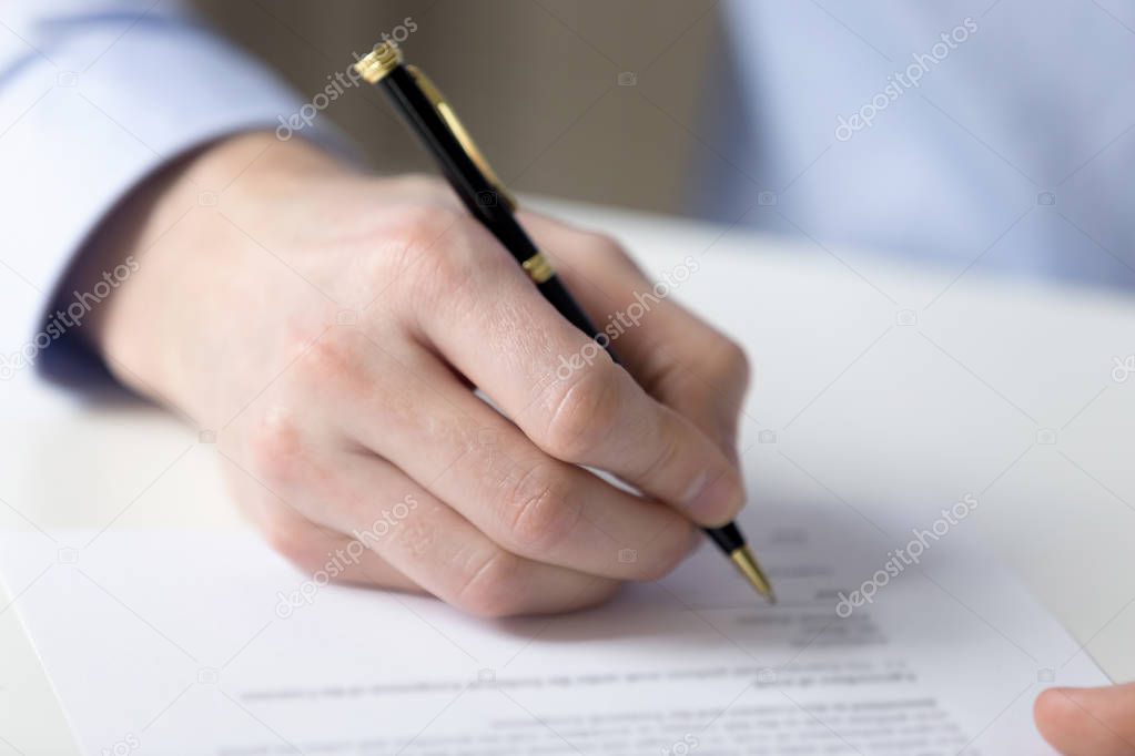 Close up male hand fill contract paper