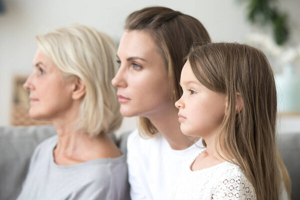 Profile family portrait, grandmother, mother and little daughter