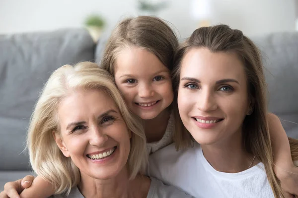 Head shot portrait of smiling grandmother, mother and daughter — Stock Photo, Image