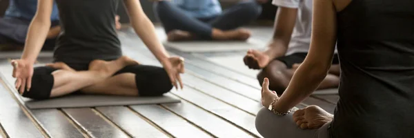 Grupo fotográfico horizontal personas sentadas en posición de loto practicando yoga — Foto de Stock
