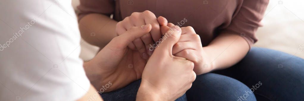 Close up panoramic image caucasian couple in love holding hands