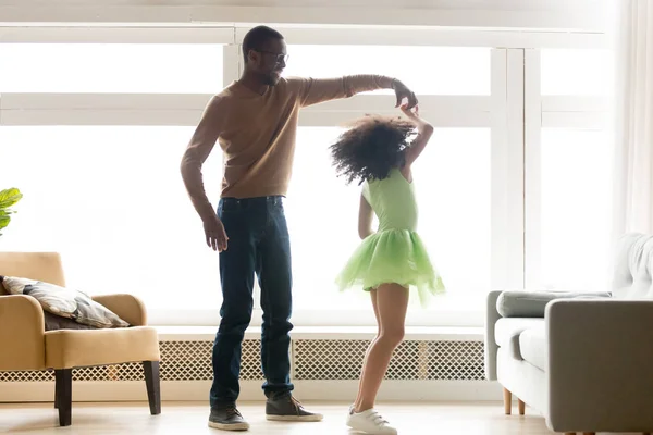 African father holding hand of child daughter dancing with princess — Stock Photo, Image