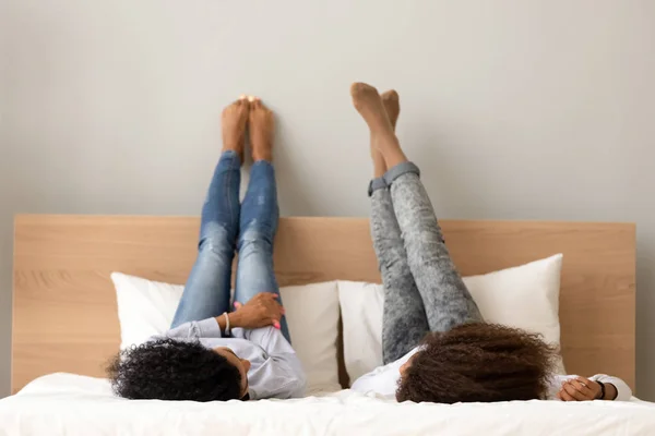 Africano fidanzate sdraiato chat su letto sollevato gambe fino — Foto Stock