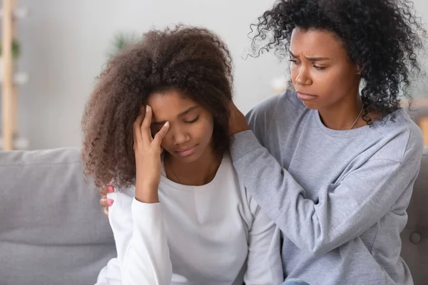 African young mother calming frustrated unhappy daughter — Stock Photo, Image