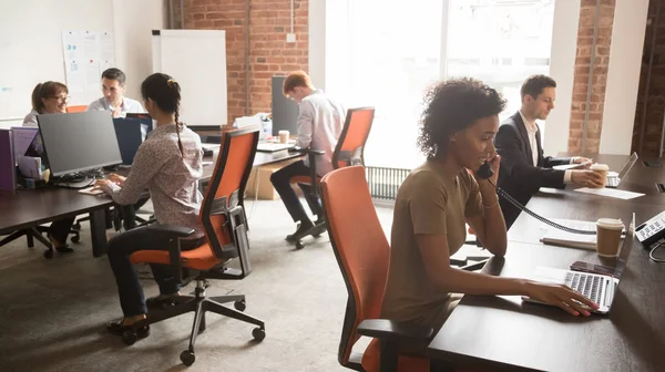 Diverse staff employees group working on computers in modern office